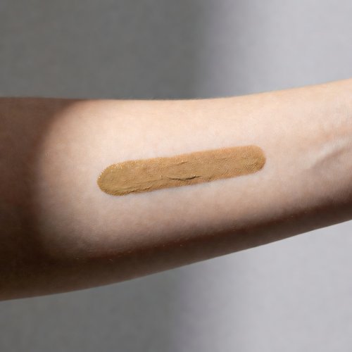 Foundation swatch on forearm, studio flash