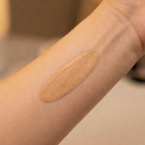 Foundation swatch on forearm, indoor tungsten light